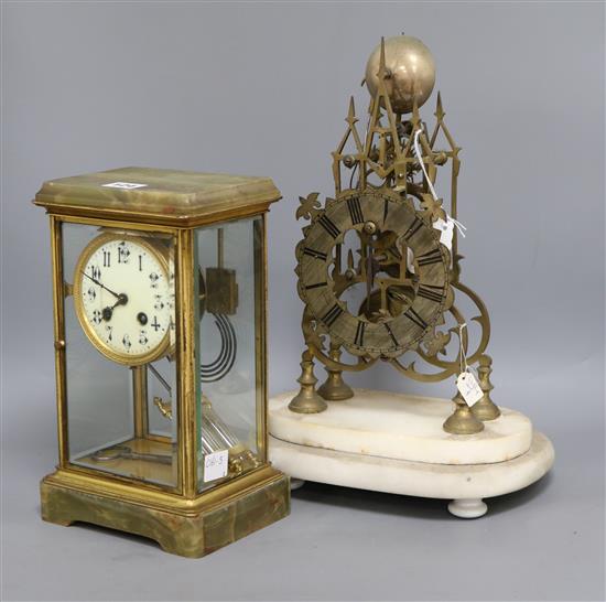 An onyx four glass clock and a skeleton clock